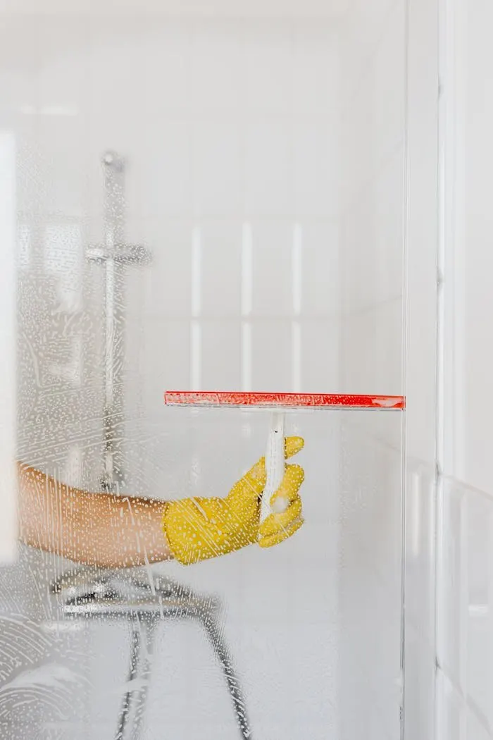 Cleaner wiping down a kitchen surface